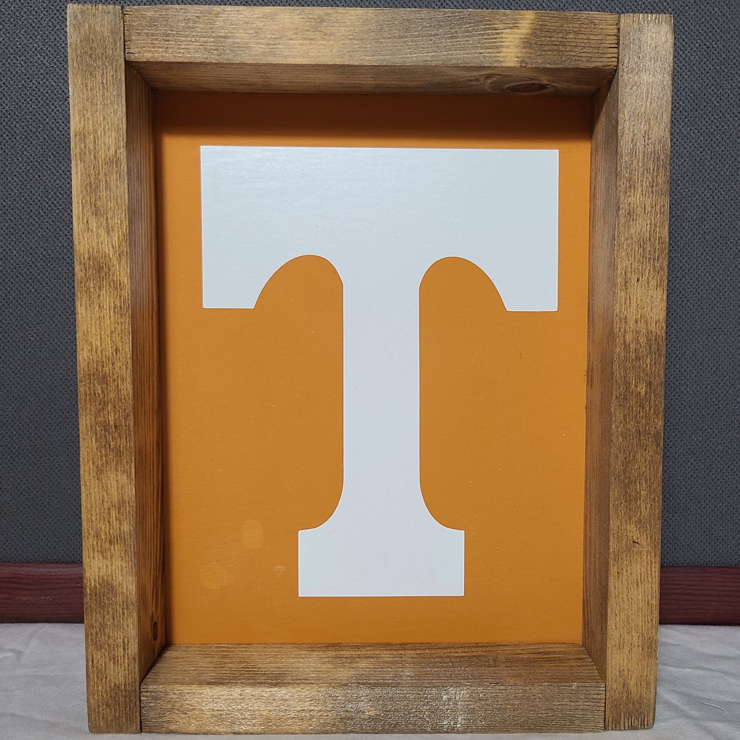 Wooden frame with a white and orange cutout design