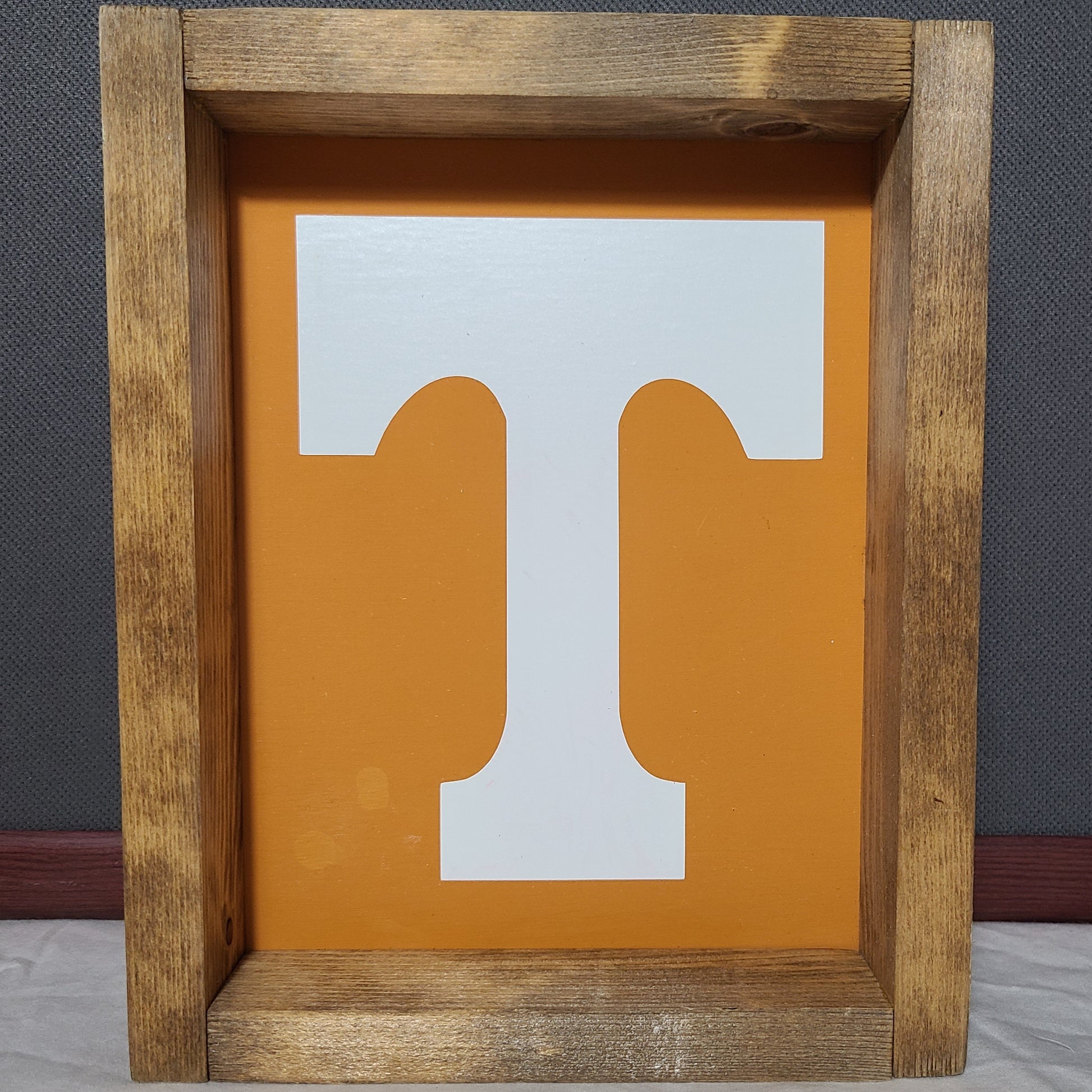 Wooden frame with a white and orange cutout design